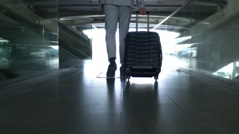 Low-section-of-businessman-with-suitcase-in-airport